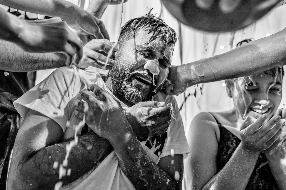 Groom drenched in coconut milk by his friends during a Roce