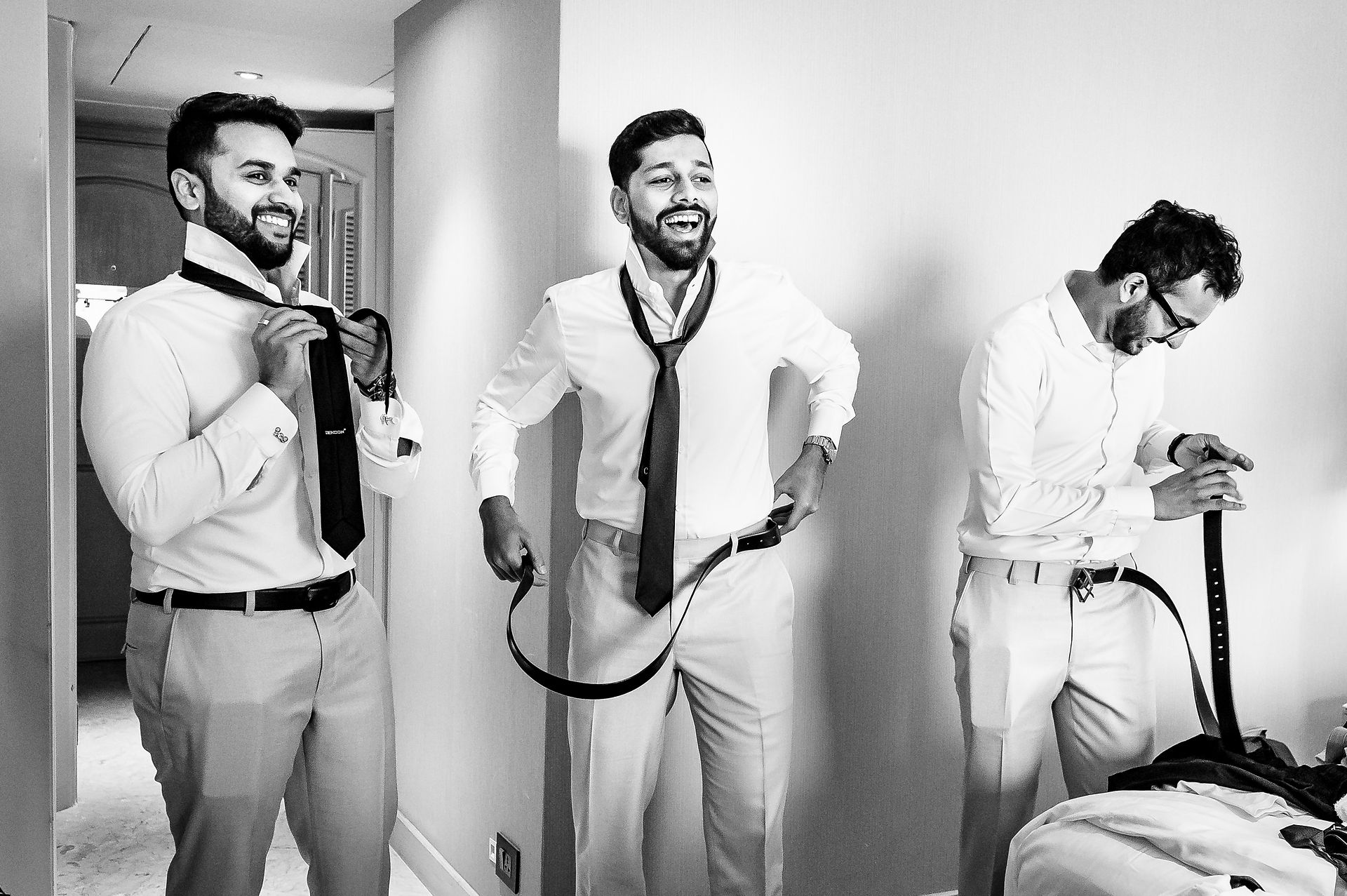 Groomsmen sharing a laugh while getting ready together 
