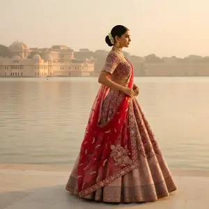 Crimson blush lehenga, destination wedding bridal, lake palace shoot, regal Indian fashion, sunset.