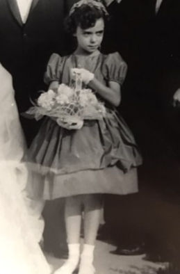 My debut as a flower girl circa 1960 guarding my flower basket like it's my job.