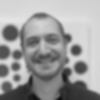 Smiling man in front of a dot art About the reproductive process.