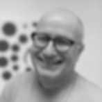 Smiling man wearing glasses with a shirt that says AMS, Reprobiol.be