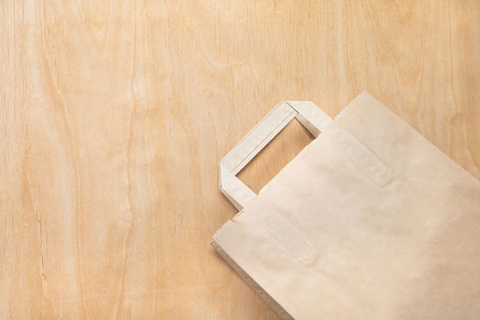 clean-brown-kraft-paper-bag-lying-on-a-plywood-tab-2025-03-10-13-43-38-utc_edited.jpg