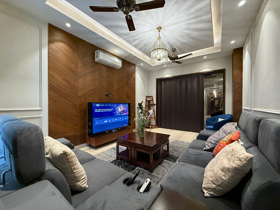 The living room with a state of the art divider and a suave suede grey sofa.