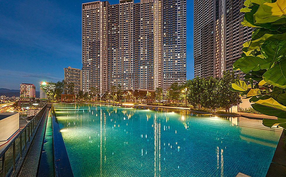 Rooftop swimming pool with city skyline at night