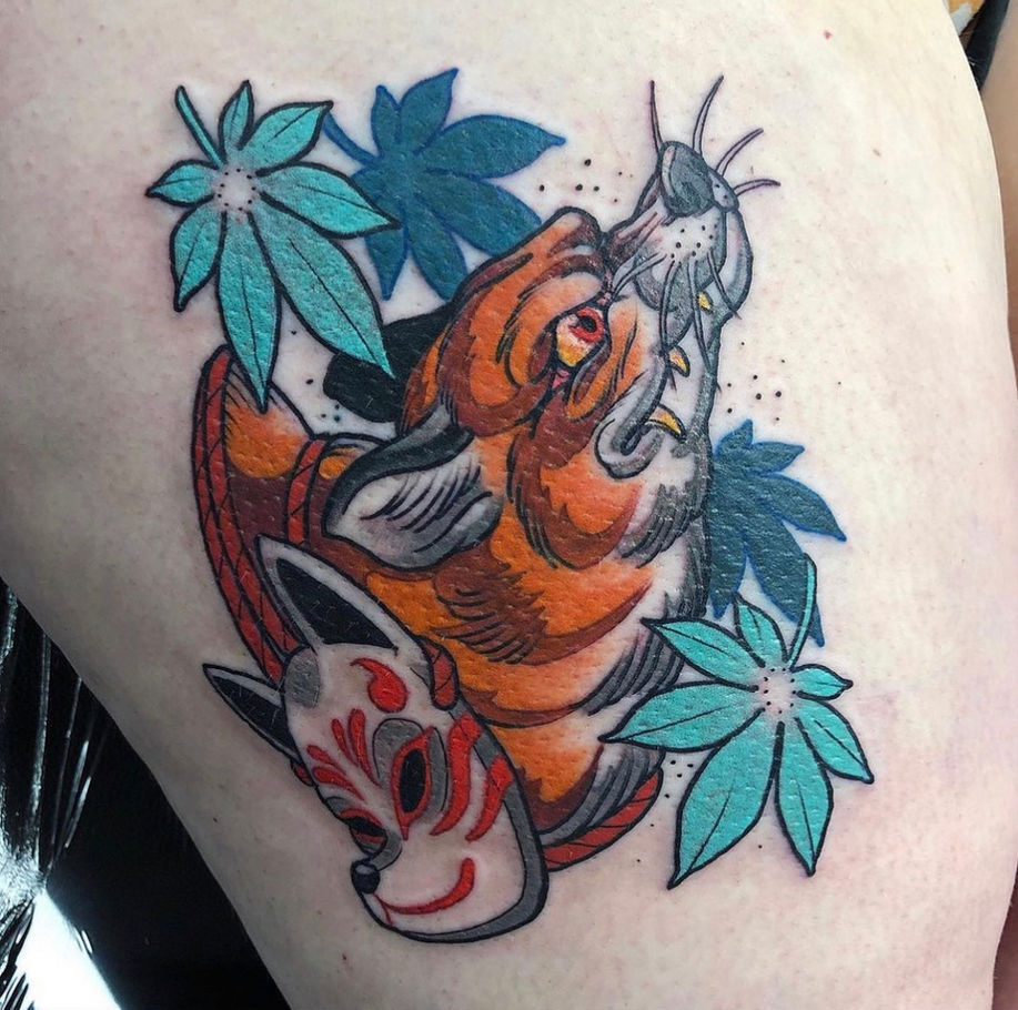 traditional japanese inspired tattoo with neo influence showing a cheeky kitsune fox and mask with maple leaves falling 