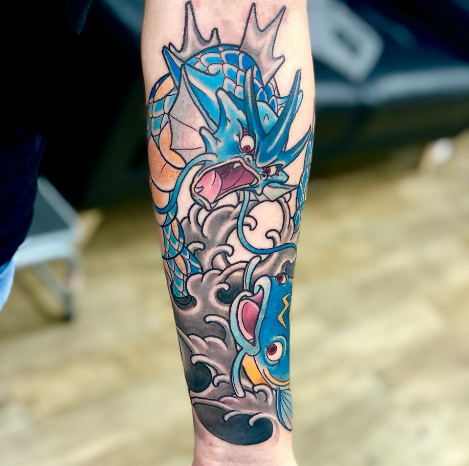 pokemon and japanese inspired tattoo featuring gyarados and whiscash in japanese waves with added koi inspired scales