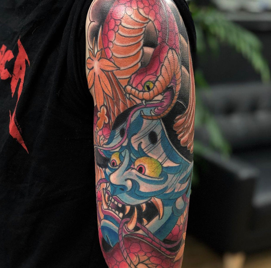 traditional japanese half sleeve with neo traditional influence done in colour showing a snake and hannya mask 