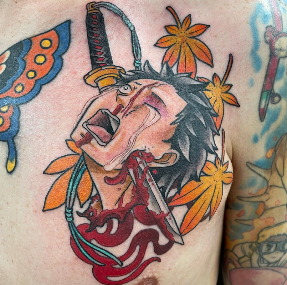 chest panel tattoo of subaru from the anime series re:zero as a japanese style namakubi severed head 