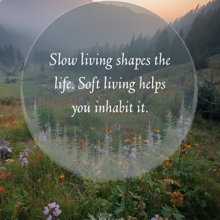 Misty mountain meadow at sunrise with wildflowers and quote: Slow living shapes the life.
