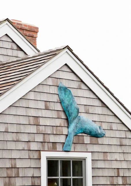 Whale tail copper sculpture in a patina finish of shades of blue on house_Nantucket Coppersmith.webp