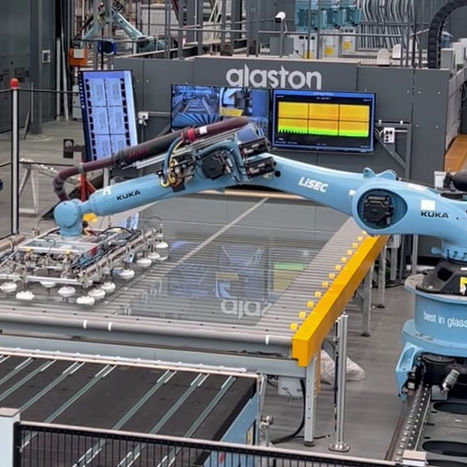 Automated robotic arm operating glass handling machinery — EESElectrics CNC and glass equipment support.