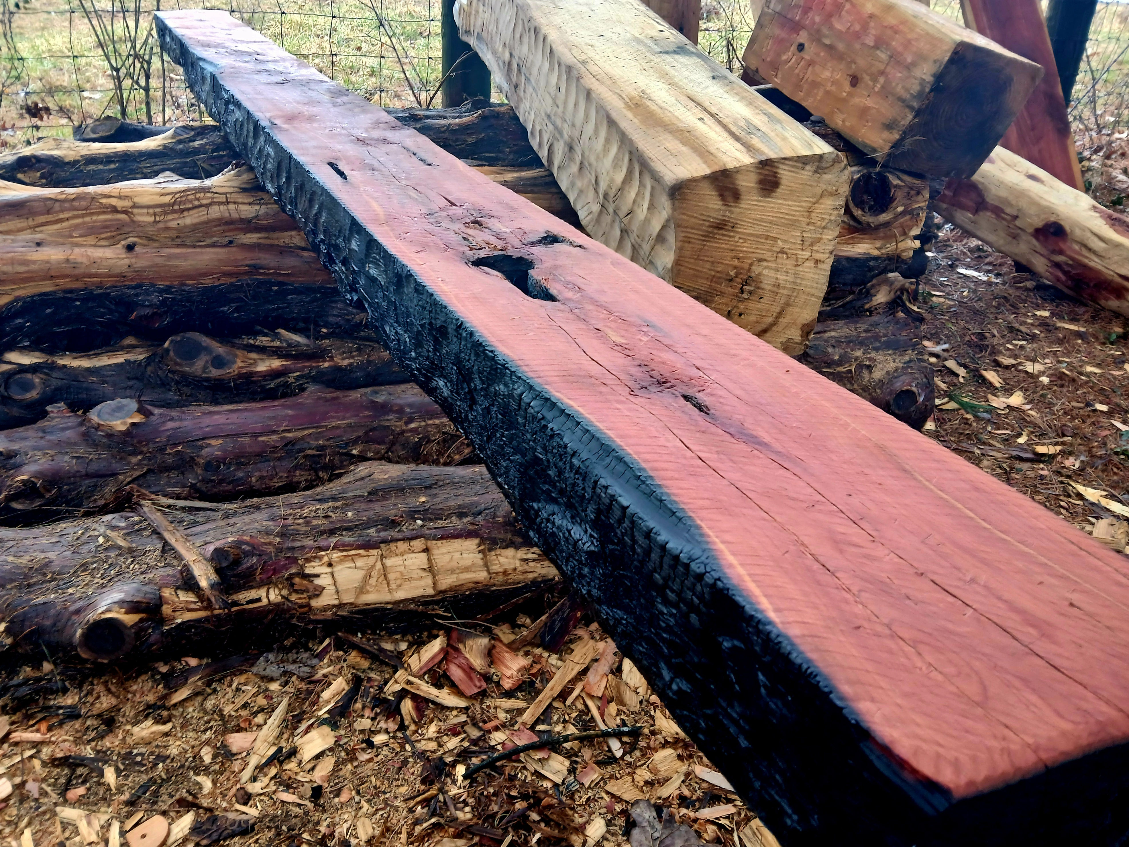 carved cedar mantel with shou sugi ban finish