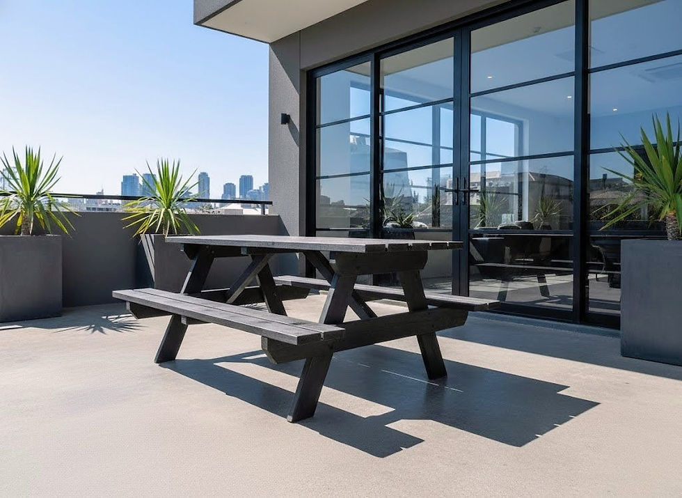 Black timber picnic table on a modern urban patio with city skyline in Melbourne, perfect for a cafe or rooftop bar.