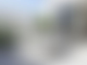 White timber picnic table on a bright modern patio with lush plants, styled for a clean and airy Melbourne courtyard.