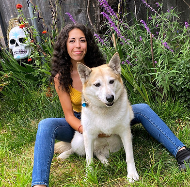 Owner Layla pictured with her dog Mia in a garden.