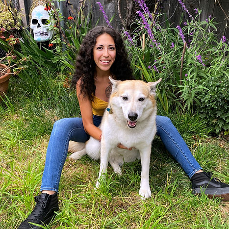 Owner Layla with her dog Mia in a garden.