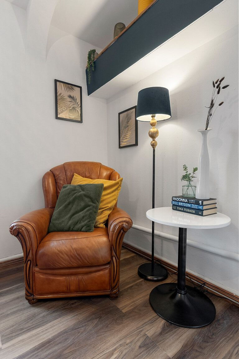 Cozy corner with leather armchair and floor lamp