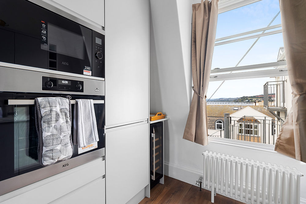 Modern kitchen with built-in appliances and window view