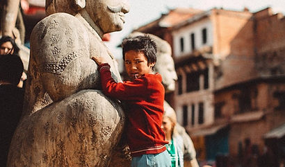 Boy Standing Next to Statue