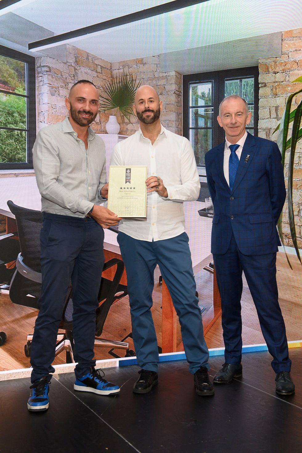 Mike Sirivianos and Karl Sessions receiving the five-star Best Office Interior Cyprus award for No11 Archimidous.