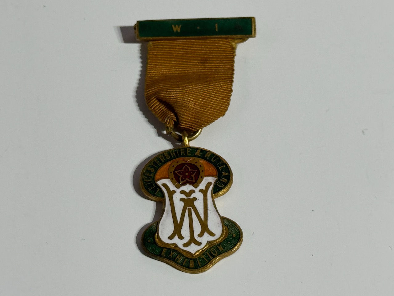 Leicestershire & Rutland W.I. Exhibition Enamel Badge