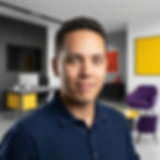 Joe, co-founder of Semiya agency, posing in a modern, brand-inspired office interior.
