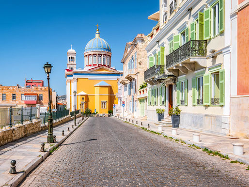 Street with colorful buildings in town center of Ermoupoli, Syros. Header image related to the blog post "Meet Syros, the Greek island that's nothing like the others"