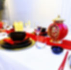 Crimson, black and gold opulent table setting with chinese decor