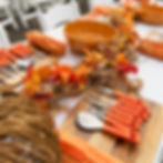 Pumpkin carving tools and wooden chopping boards with orange and gold decor