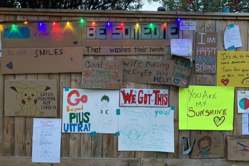 fence with hand-lettered signs