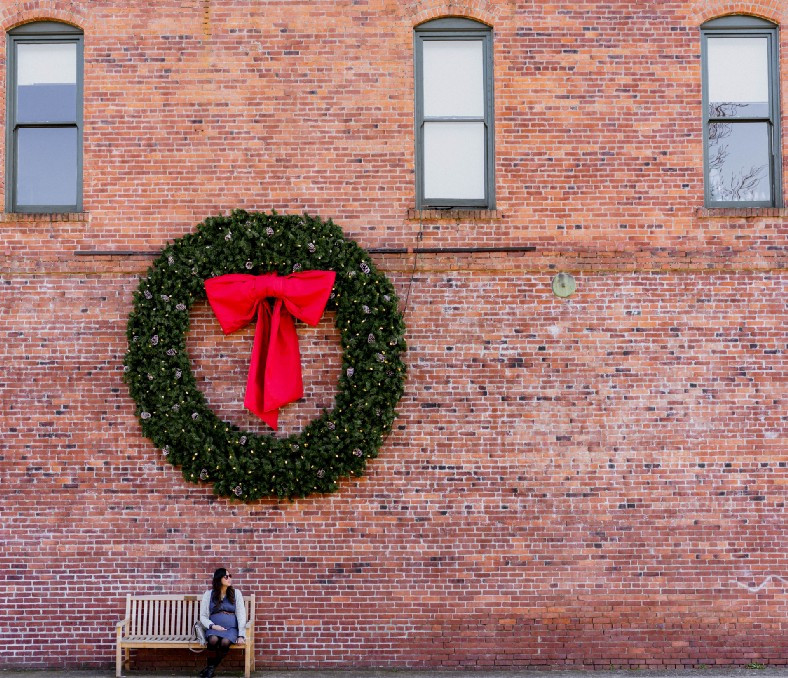 Large wreath on brick building wall