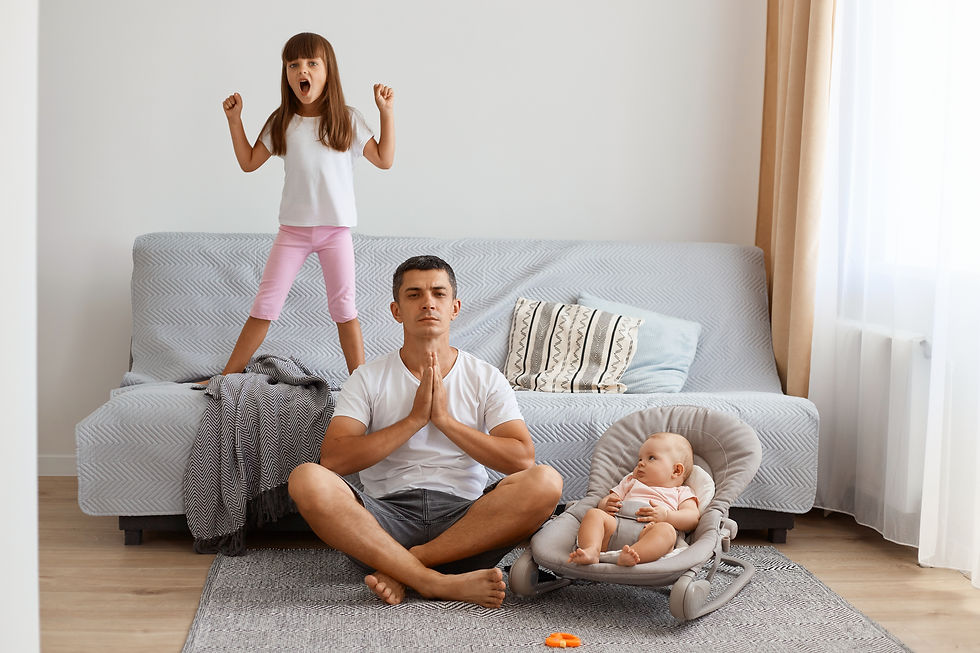 Meditating father with his toddler and infant daughters watching him