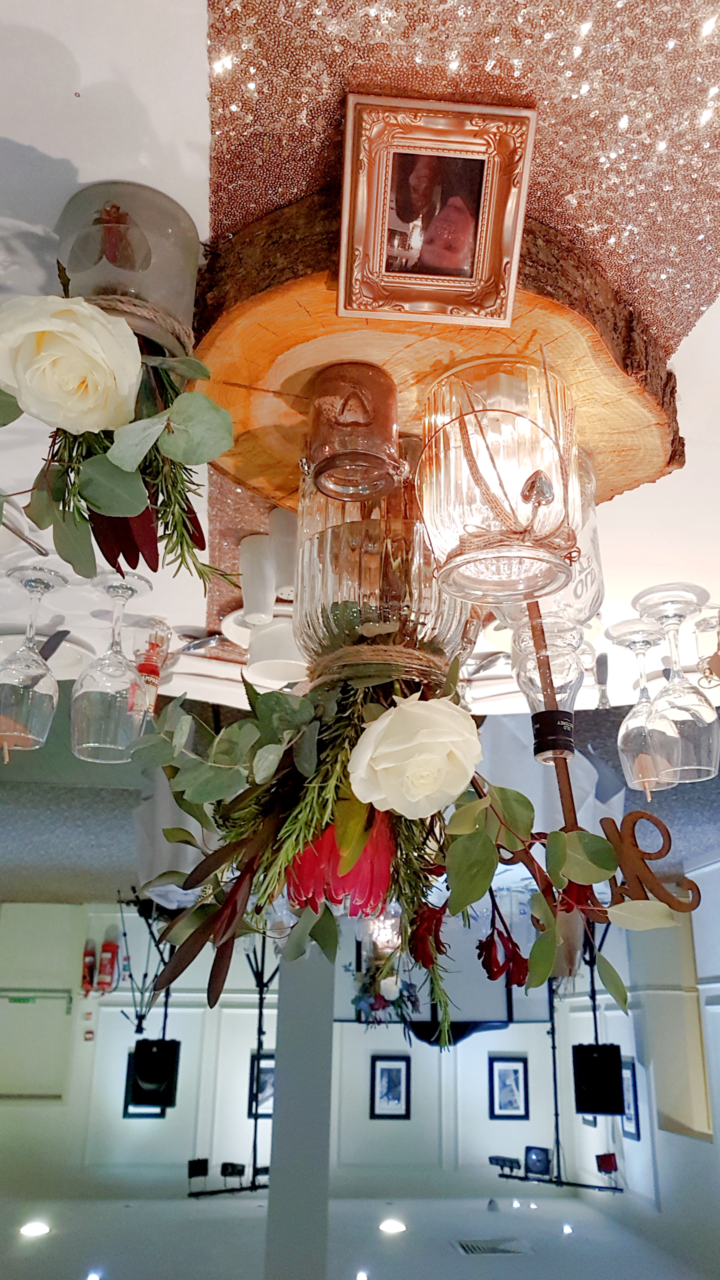 With Fresh Protea, Ivory & Pink Roses, Gypsophila & Eucalyptus Plus Duo Of Rustic Vases.