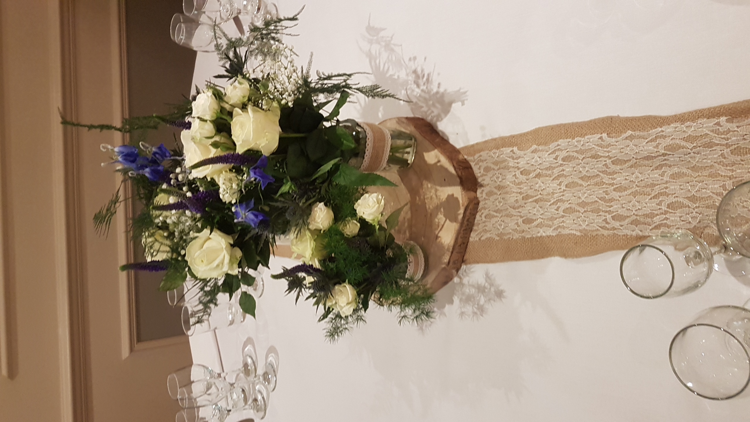  With Fresh Tree Fern, Ivory Roses & Delphinium.