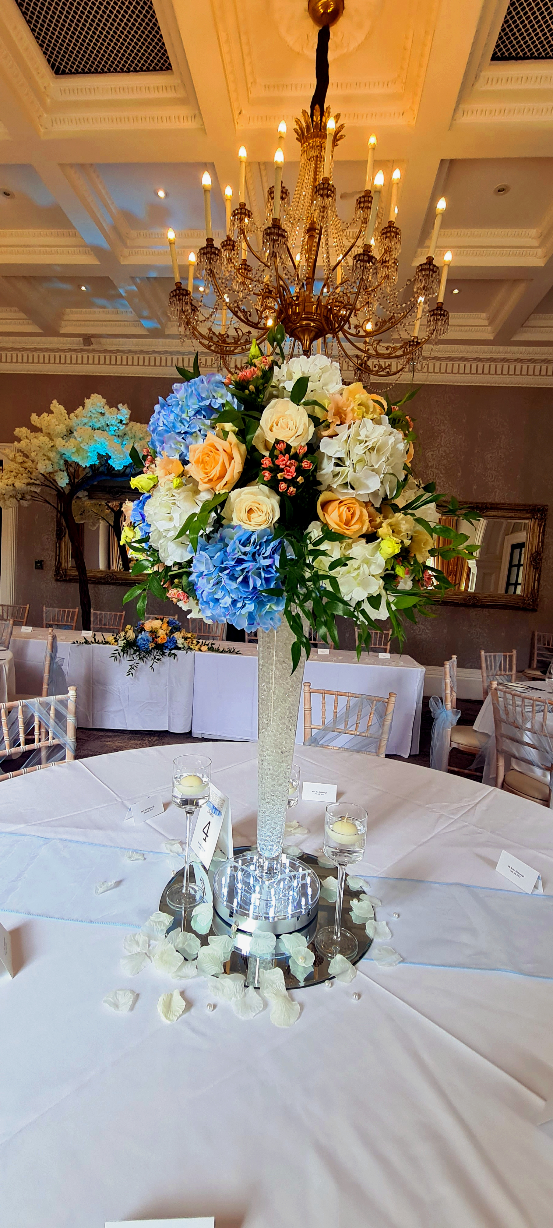 With Fresh Peach, Coral & Blue Flowers.