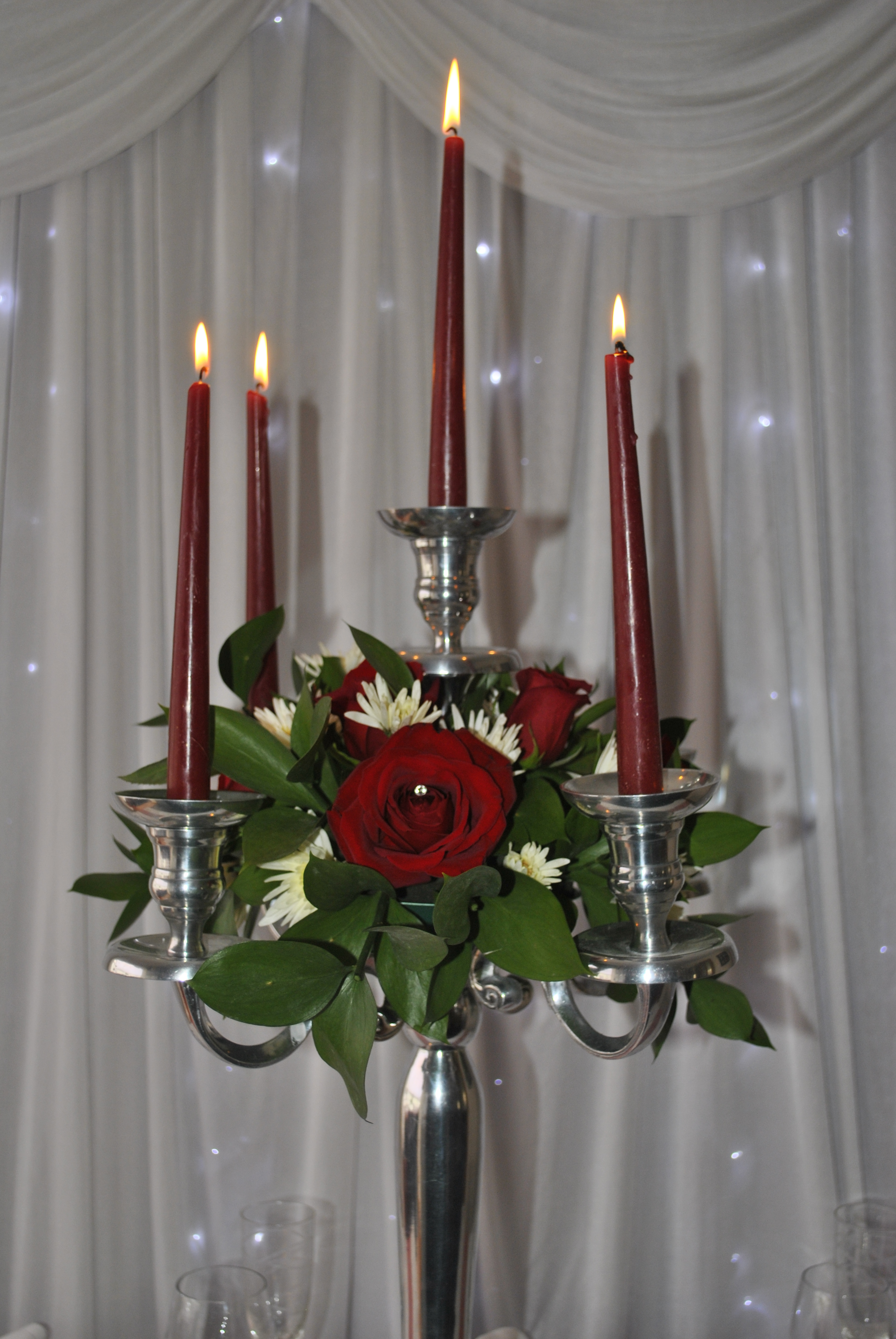 Candelabra with fresh flower wreath