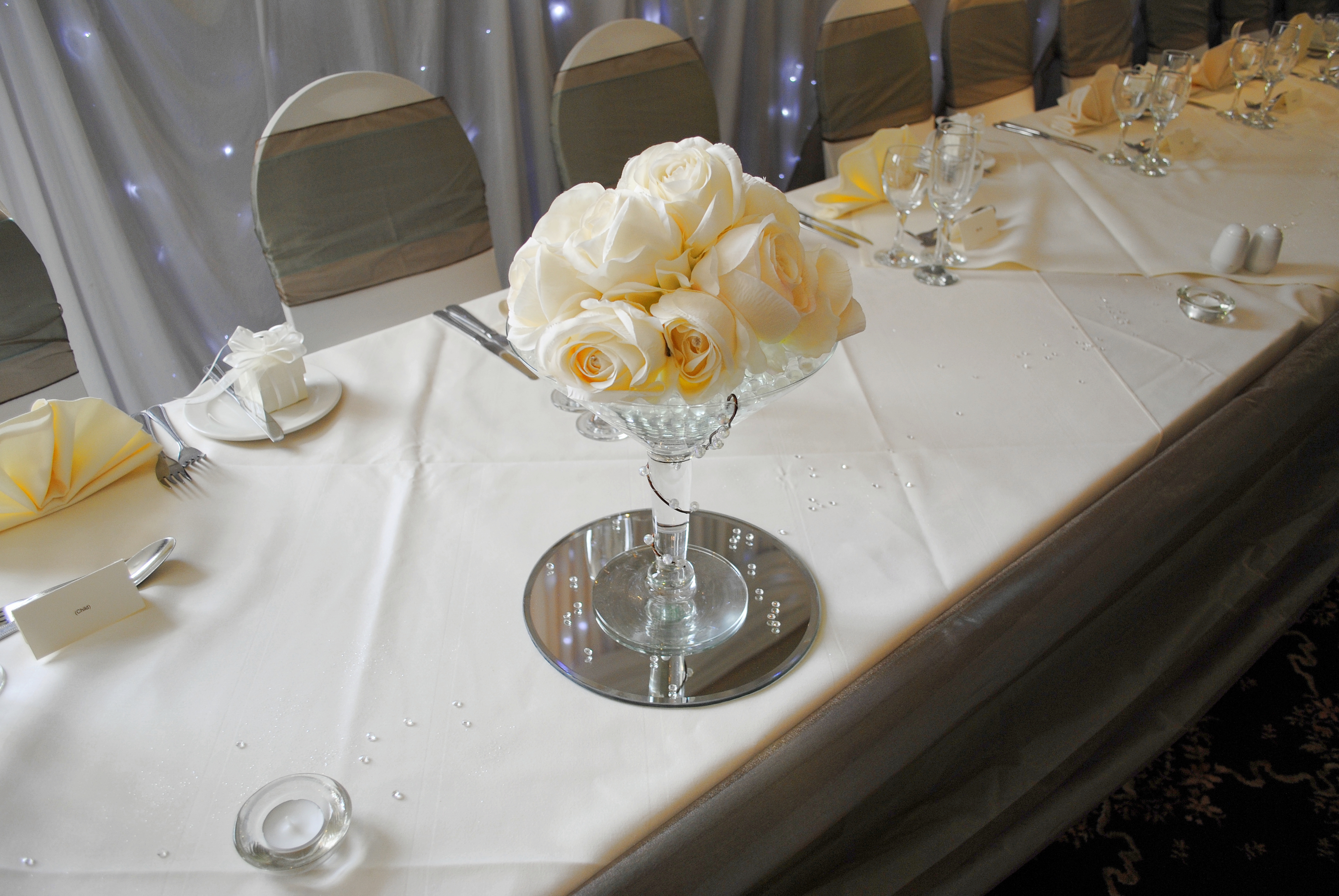 With Artificial Cream Roses.