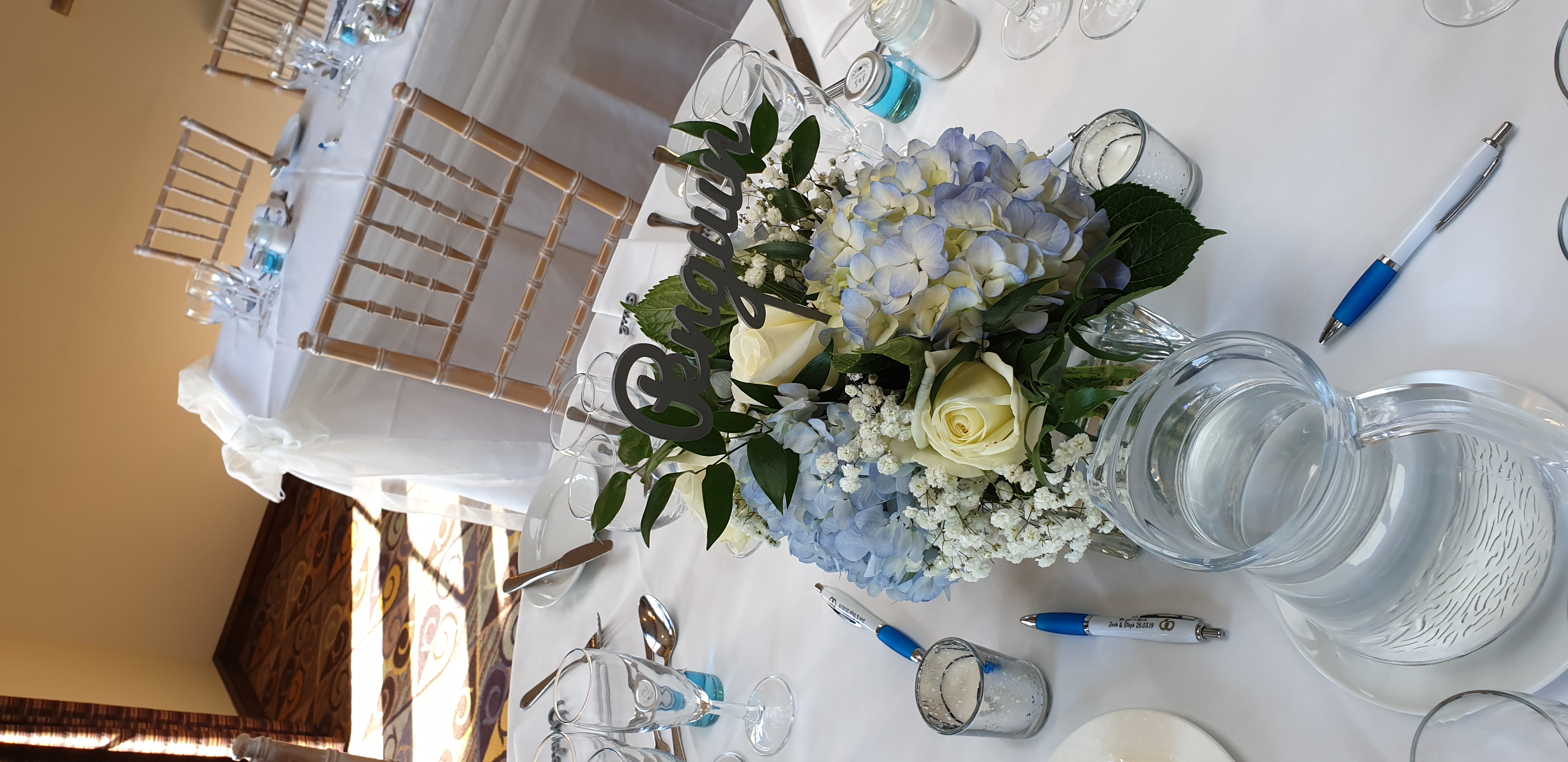With Fresh Ivory & Blue Mixed Flowers.