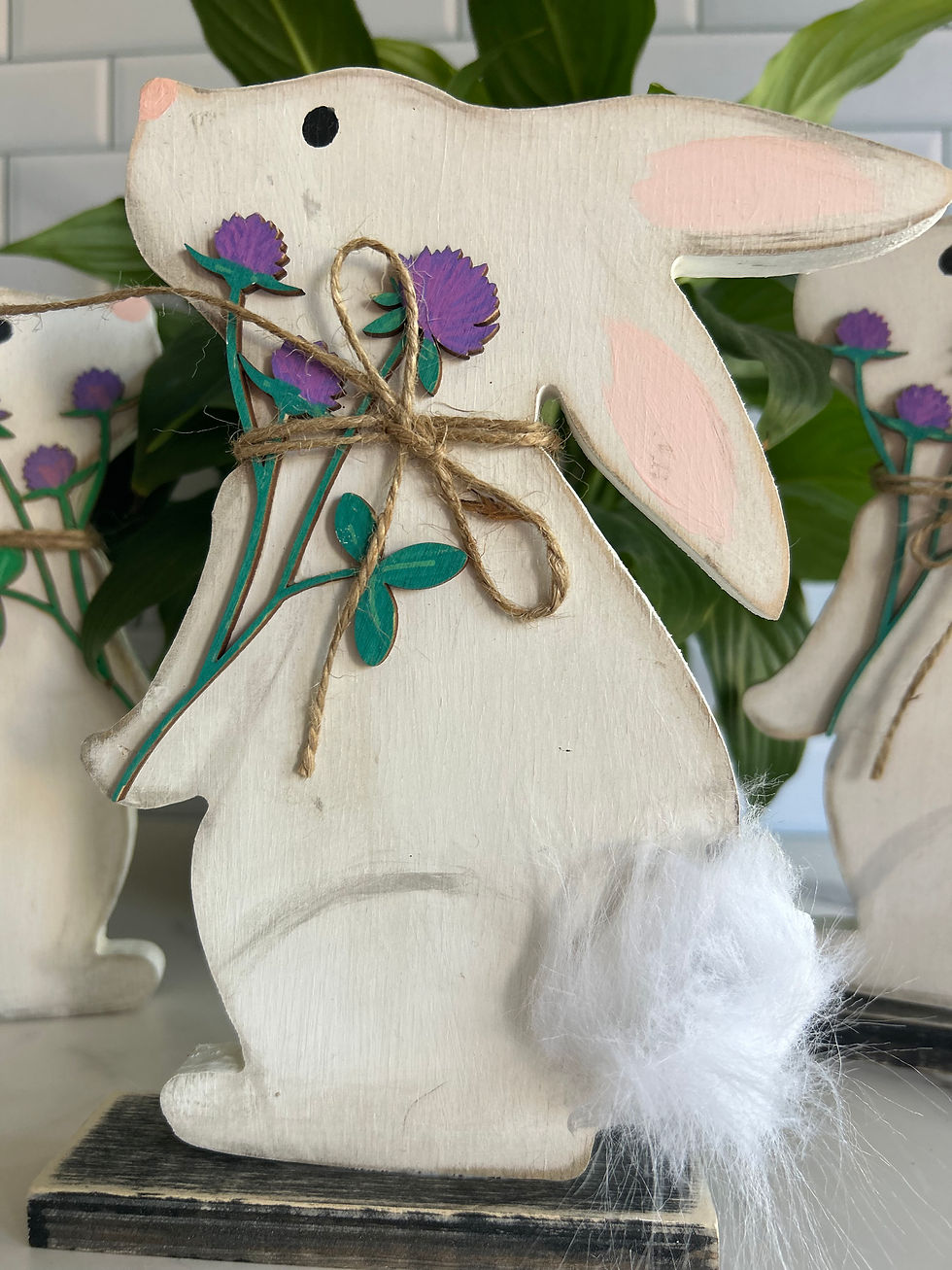 Thumbnail: Wooden bunny shelf sitter carrying a bunch of clover