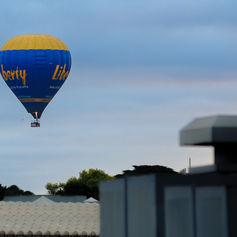Hot air ballon over buildings