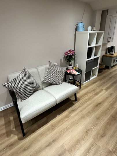 A welcoming area with a comfortable sofa for you to sit on arrival of your nail or beauty appointment 