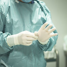 medical healthcare staff wearing infection prevention control gloves mask gown hand hygiene