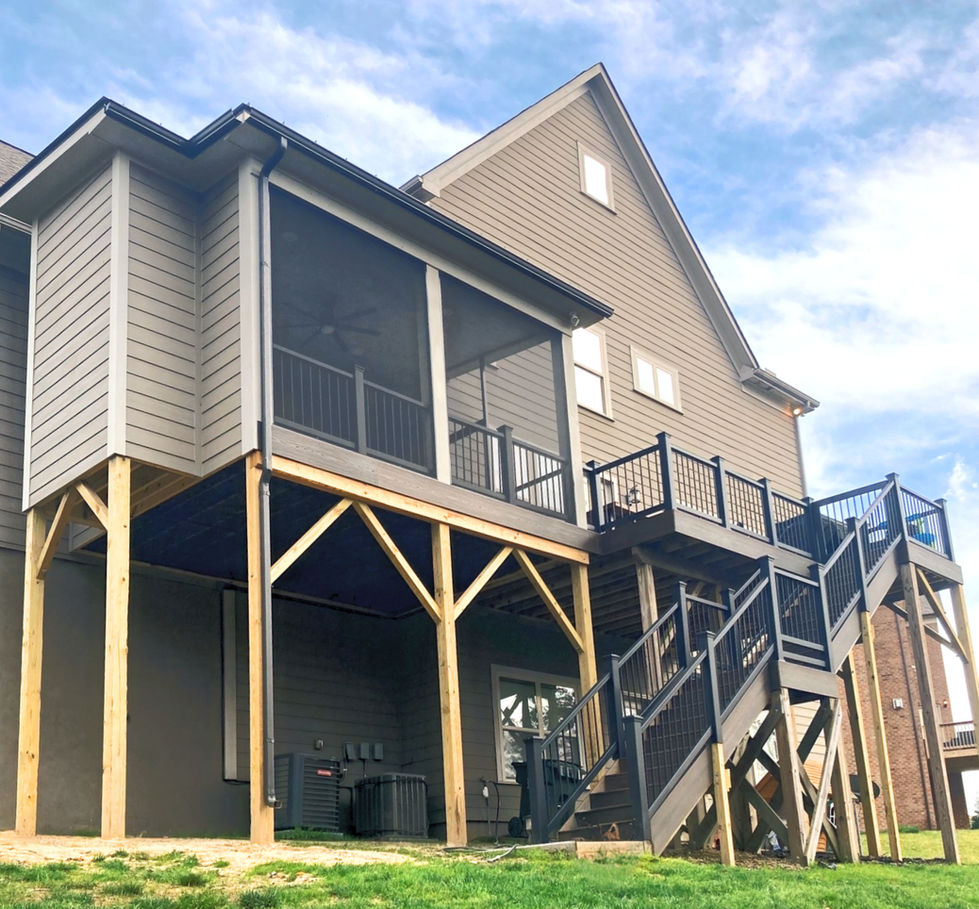 a house with a screened in porch, deck and stairs