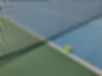 tennis-ball-on-hard-court-next-to-net.jpg