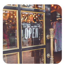 Open sign displayed at a grand opening event, welcoming guests to a new corporate venture."