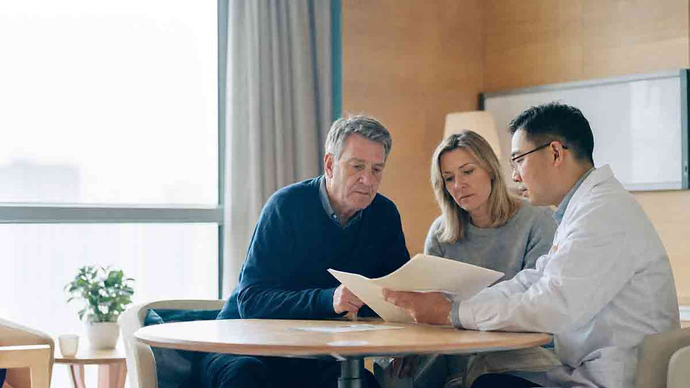 Western patient and family member reviewing medical records with a Chinese neurologist during a Parkinson’s consultation in China.