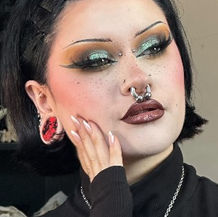 A gothic-inspired coffin-shaped eyeshadow palette featuring a range of dark, moody shades, exemplifying @_dropdead_gorgeous's unique blend of alternative beauty and home decor products.