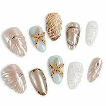 A set of medium-length almond-shaped press-on nails painted with an ocean-themed design: soft aqua and sea-blue base with glittering golden outlines. The nails feature decorative motifs including seashells, starfish, and seahorses, with shimmering gold accents that evoke a “gilded-seashell under sea” fantasy aesthetic. The nails are laid out in a fan-like arrangement against a plain background, showing their shape and detailed artwork.