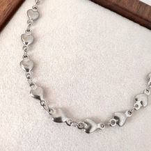 Minimalist gold-tone Aveline chain necklace with fine polished links, designed for layering with charms or wearing alone.